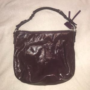 Dark purple patent leather Coach bag.